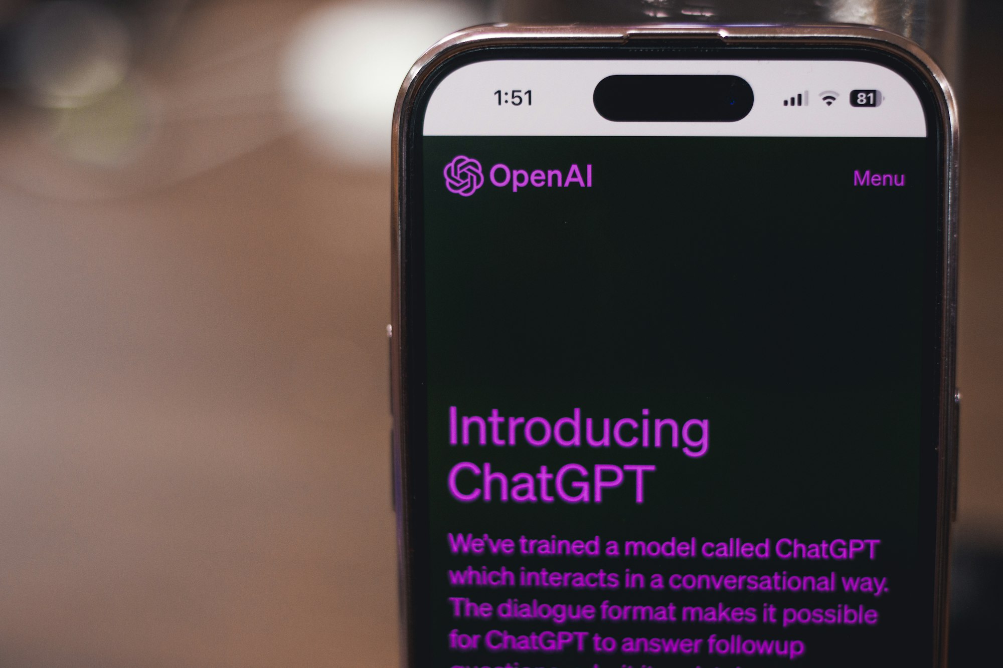 Webpage of ChatGPT, a prototype AI chatbot, is seen on the website of OpenAI, on a smartphone. Examples, capabilities, and limitations are shown.